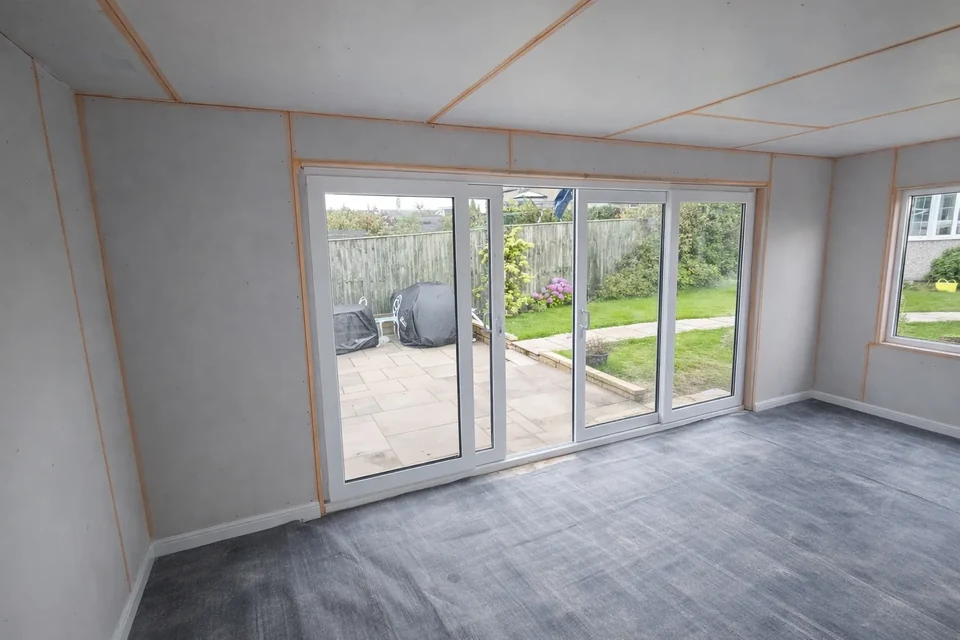 Boarded room and glazed doors during renovation