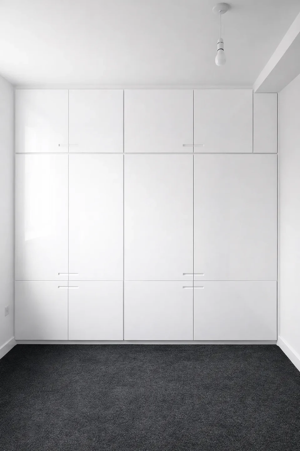 White fitted wardrobes with full-height doors.