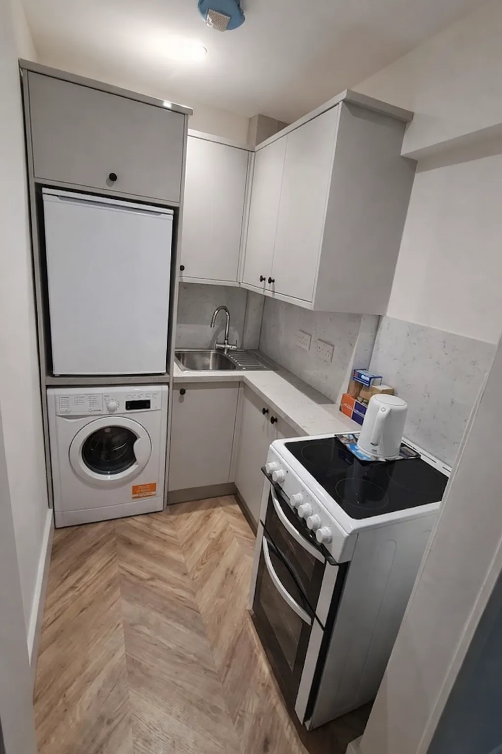 Completed fitted kitchen with herringbone flooring in Edinburgh